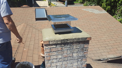 Chimney inspection on a residential shingle roof.