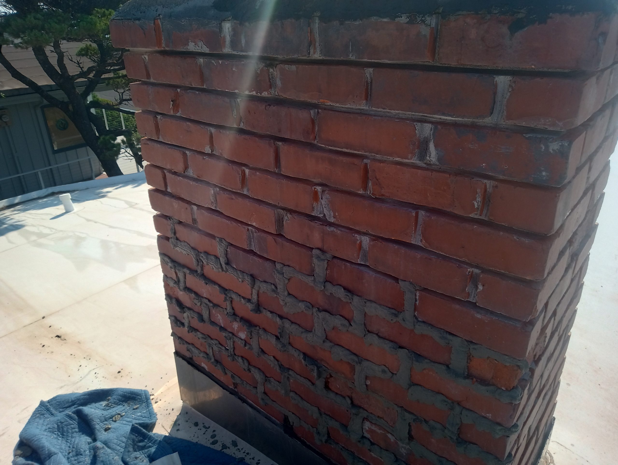 Newport Oregon - new mortar in chimney joints Newport, Oregon. Chimney mortar joint repair ("tuckpointing") New mortar in chimney mortar joints. Ready to be formed and tooled smooth.