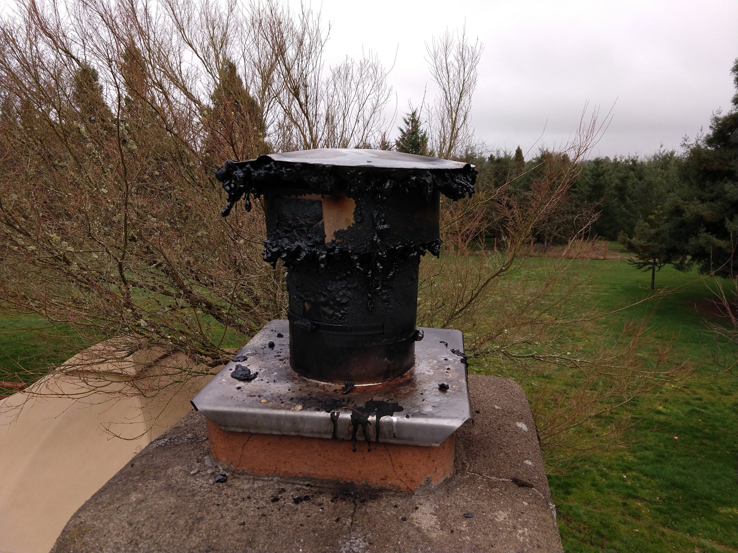 IMG_20180216_145629498 Damaged chimney rain cap resulting from a chimney fire. Portland Oregon