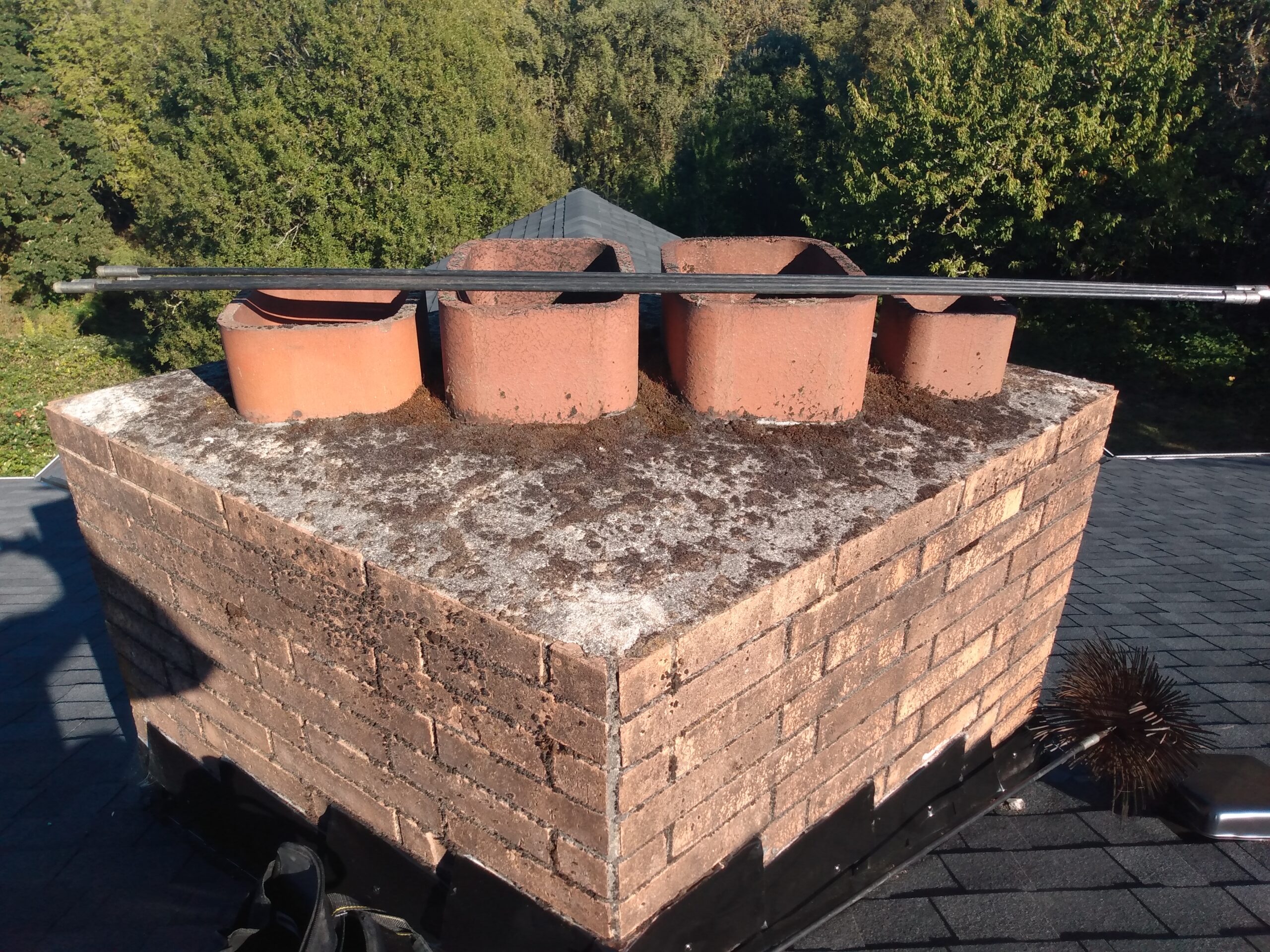 IMG_20200928_160801140 Cleaning a chimney from the bottom up, using a drill and flexible chimney cleaning equipment designed to be used with a drill. Portland Oregon.