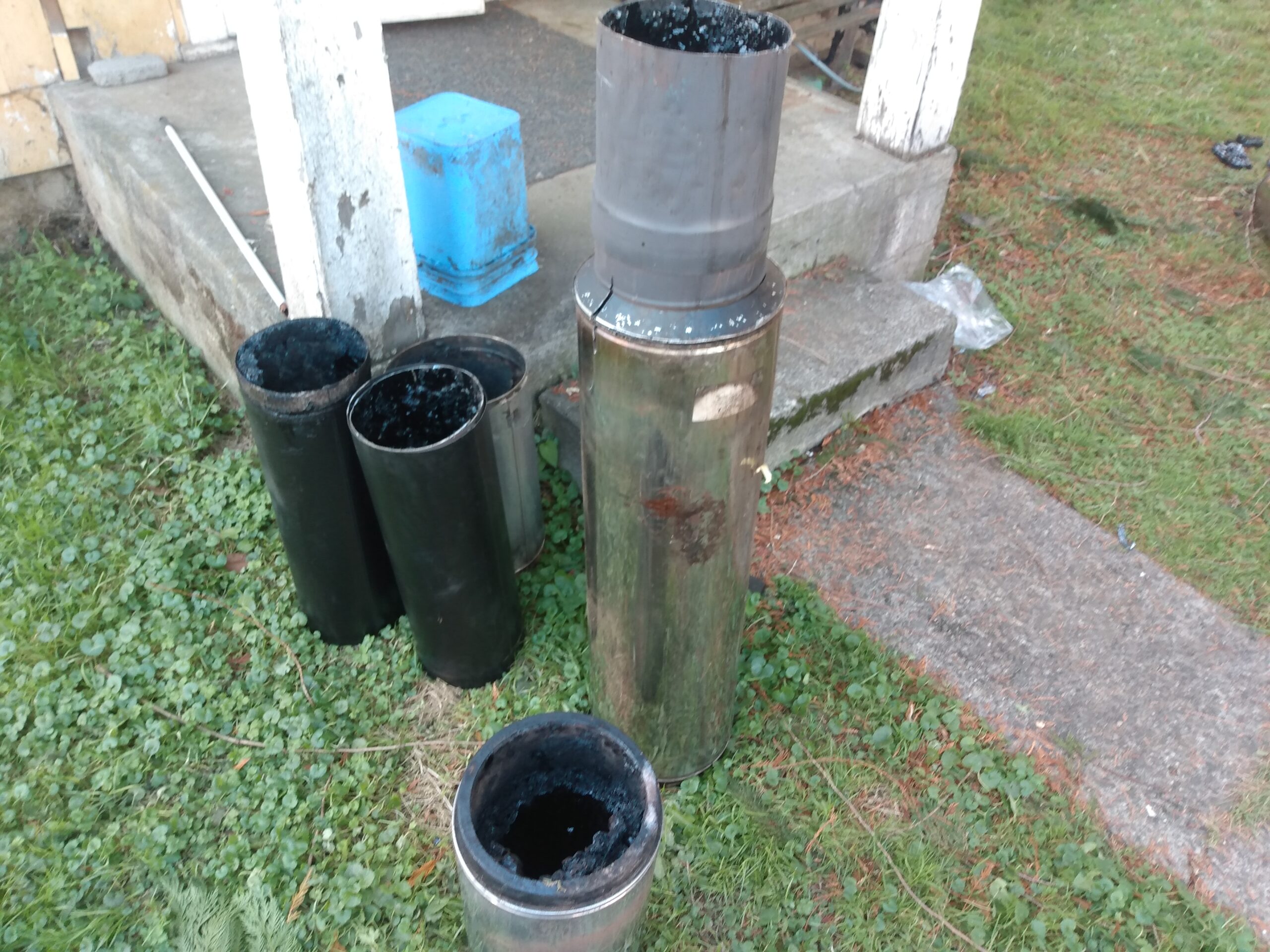 IMG_20221121_131852578 Cleaning a chimney from the bottom up, using a drill and flexible chimney cleaning equipment designed to be used with a drill. Portland Oregon.