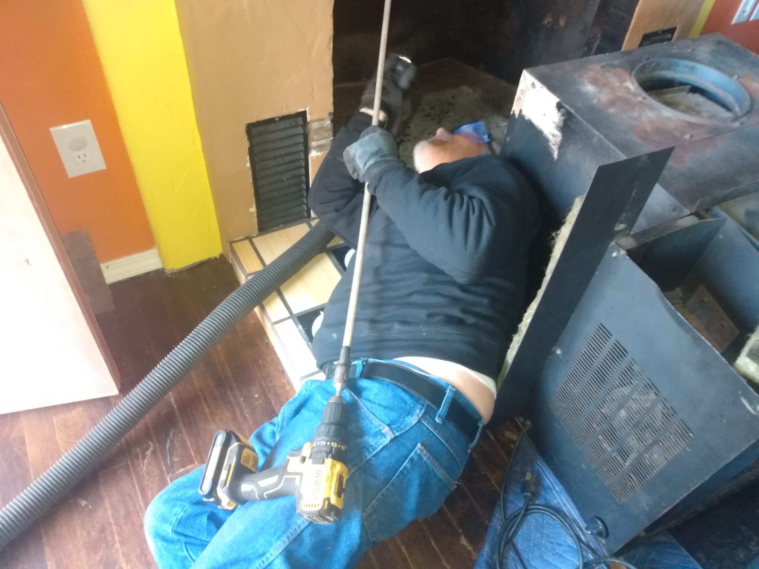 IMG_20221214_143930136(1) Cleaning a chimney from the bottom up, using a drill and flexible chimney cleaning equipment designed to be used with a drill. Portland Oregon.