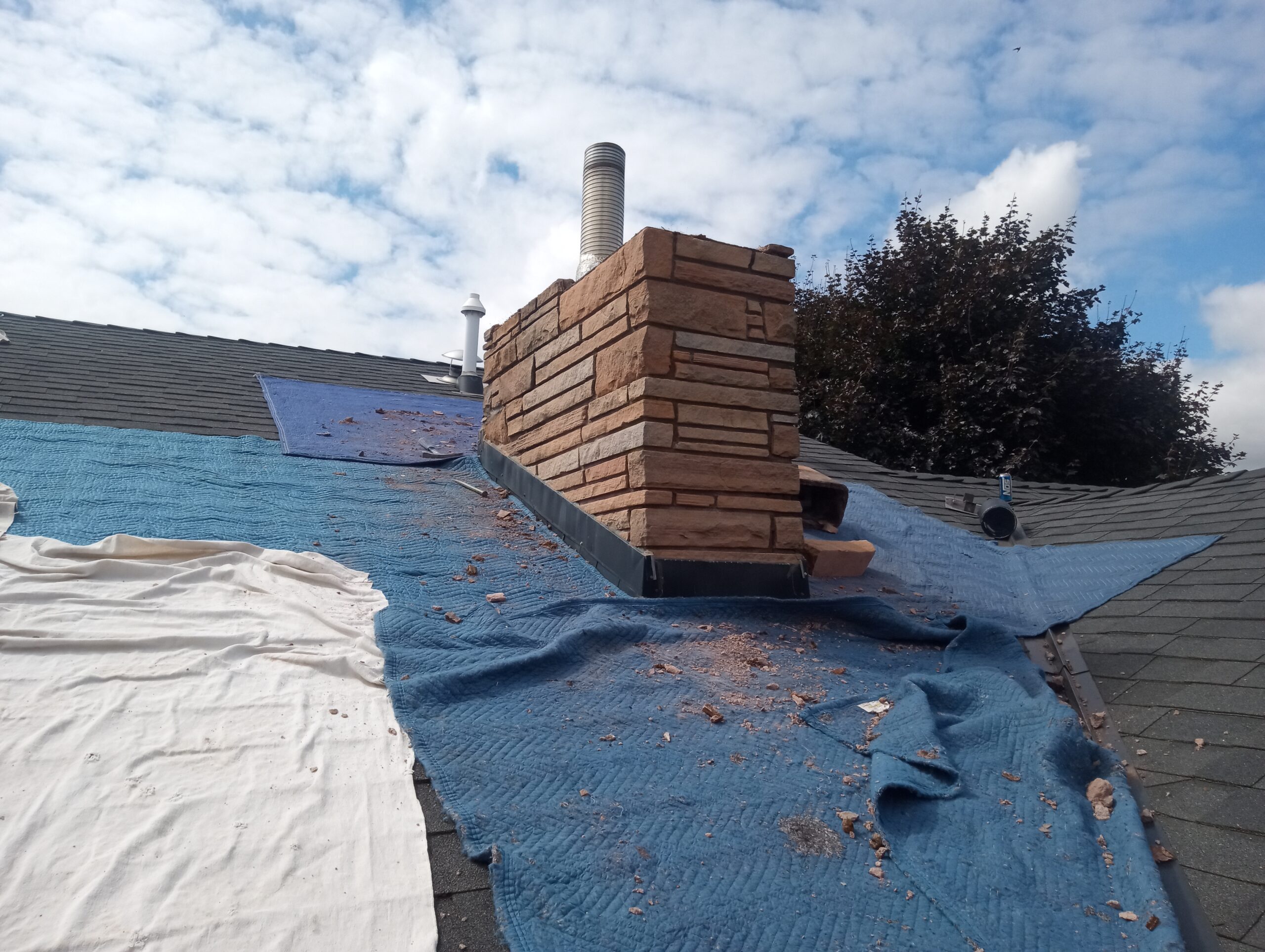 Chimney being rebuilt from roof up in Mt. Angel, Oregon